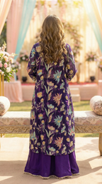 Woman wearing a purple floral embroidered cape and skirt set by Karchobi, outdoor setting