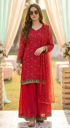 Woman modeling floral buti embroidered rani pink Chinon kurta sharara set from Karchobi
