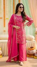 Woman in rani pink floral sequin zari embroidery kurta sharara set, festive backdrop, Karchobi