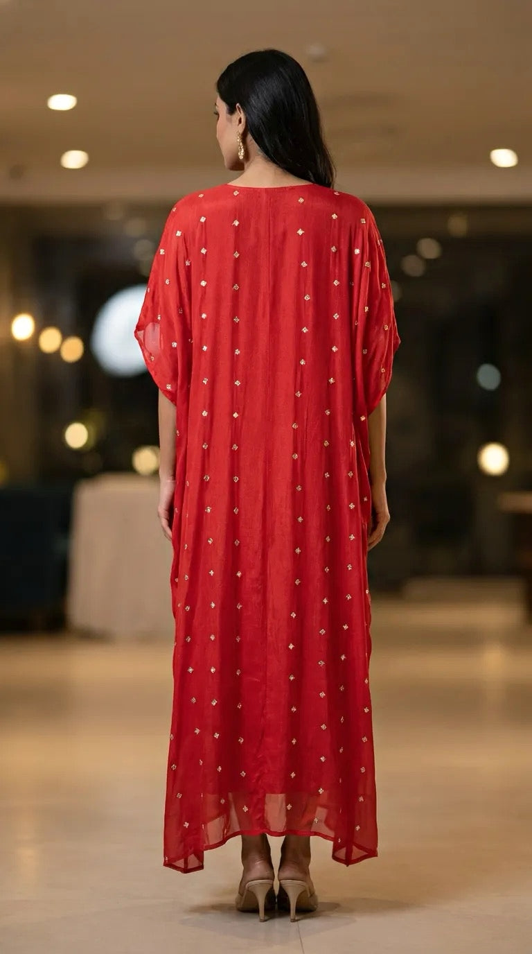 Woman wearing Karchobi red embroidered Chinon kaftan dress with gold motifs, back view