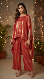 Woman in rust red shimmer kaftan pant set, festive wear by Karchobi, standing indoors