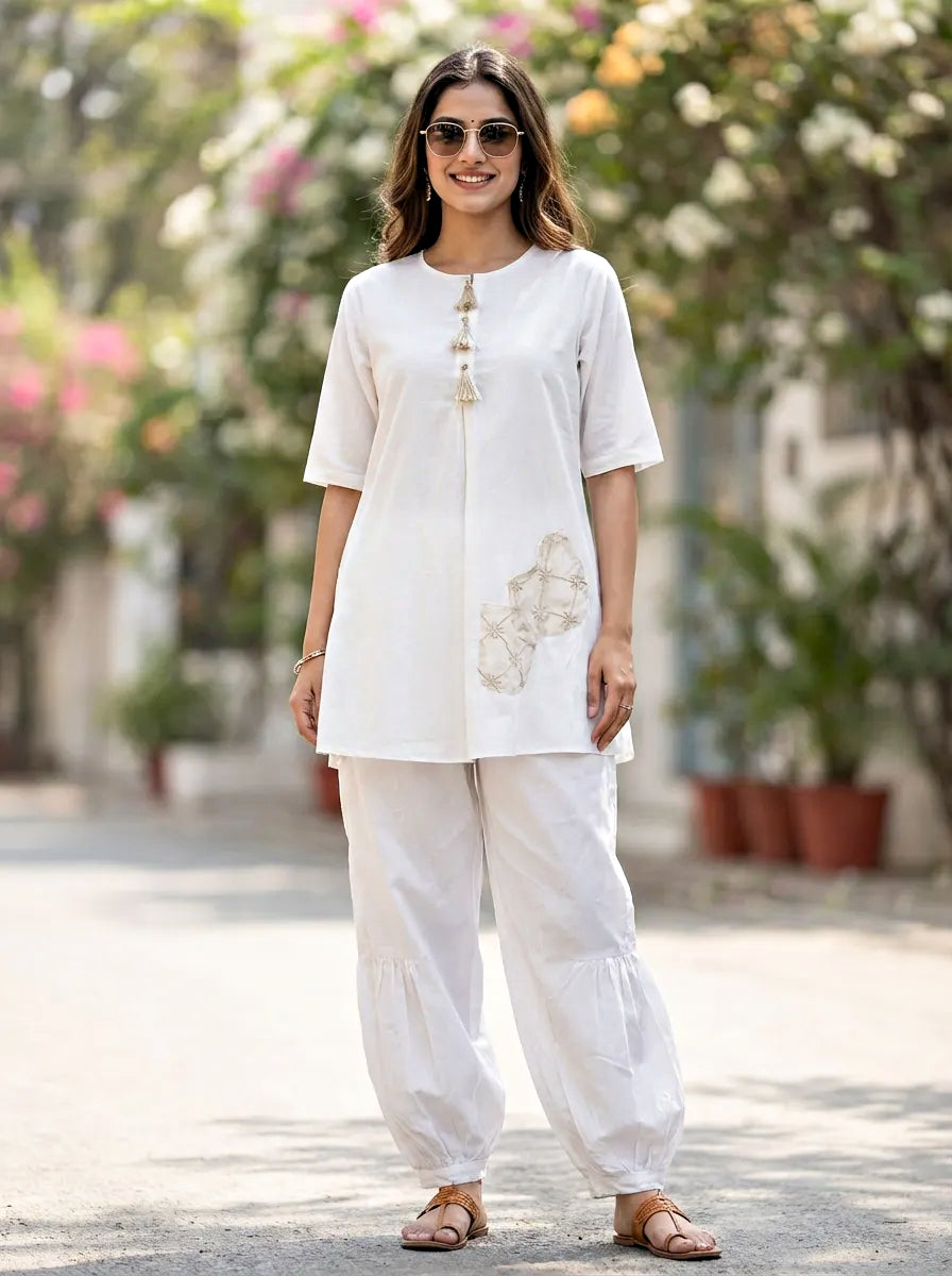 Woman wearing white cotton kurta Afghani salwar co-ord set for everyday ethnic wear