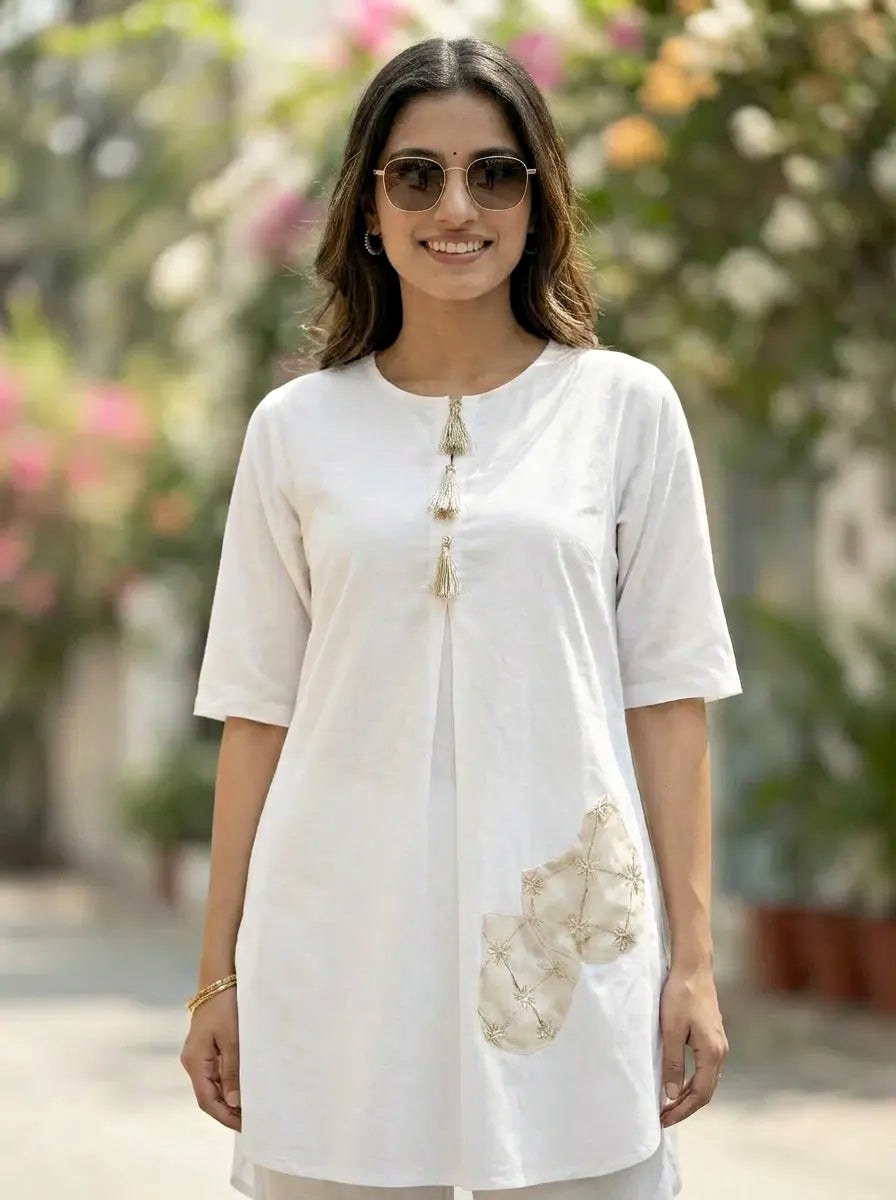 Woman wearing a white kurta afghani salwar coord set with floral patterns outdoors