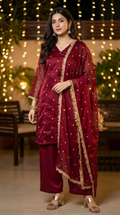 Woman in wine red gold buti kurta palazzo set with gold jhalar lace by Karchobi