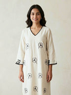 Off-white and black floral embroidered kurta dress by Karchobi with applique motifs and long, flowing design.