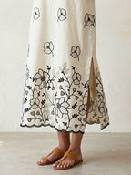 Off-white and black kurta dress by Karchobi with floral embroidered motifs and appliqué detailing, full-length traditional Indian attire